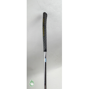 Black Scotty Cameron golf putter grip with yellow lettering and geometric pattern on a chrome steel shaft.